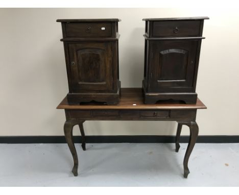 A contemporary hardwood two-drawer console table together with a pair of bedside cabinets with panel doors