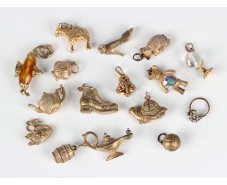 Fifteen 9ct gold charms, including a swan, a teapot, a lady's shoe and a teddy bear, total weight 28.2g, together with a foot