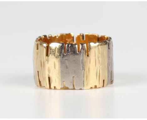 An 18ct two colour gold wind band ring in an abstract textured design, London 1973, weight 8.2g, ring size approx J.Buyer’s P