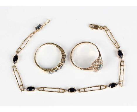 A 9ct gold and sapphire bracelet, claw set with a row of oval cut sapphires, length 18.5cm, a 9ct gold, synthetic green spine