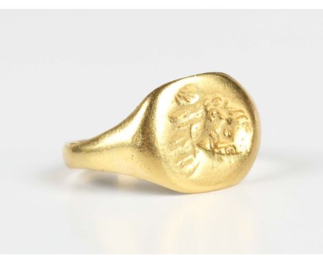 A gold oval signet ring, possibly 18th century, the intaglio designed as a portrait of a gentleman in the 17th century style,