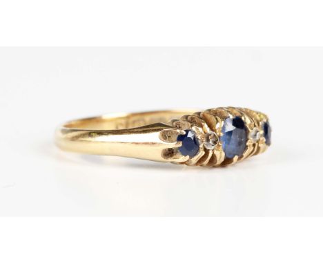 An 18ct gold, sapphire and diamond ring, mounted with three graduated oval sapphires alternating with two diamonds, Birmingha