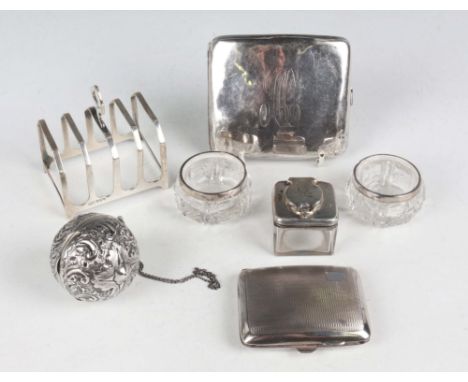 An Edwardian silver spherical hinged box with embossed scroll decoration, fitted with a suspension ring, London 1903 by Charl