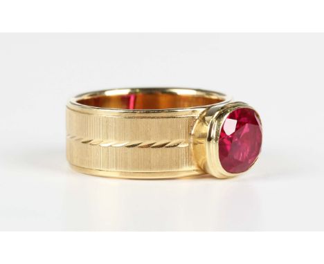 A gold and synthetic ruby single stone band ring, detailed 'Wolfgang 585', weight 6.2g, ring size approx J.Buyer’s Premium 29