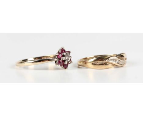 A 9ct gold, ruby and diamond seven stone cluster ring, mounted with a circular cut diamond within a surround of six circular 