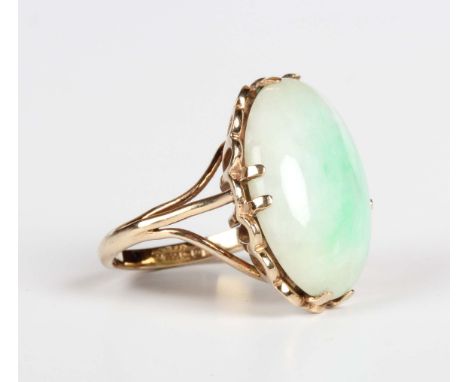 A 9ct gold ring, claw set with the oval cabochon jade between split shoulders, Birmingham 1978, weight 7.1g, ring size approx