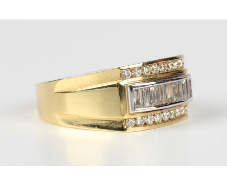 A gold and diamond ring, mounted with a row of baguette cut diamonds to the raised centre between rows of circular cut diamon