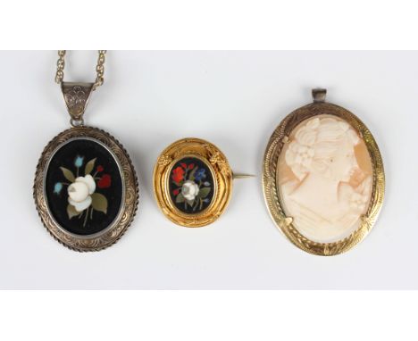 A gold mounted oval pietra-dura brooch in a floral design, unmarked, weight 5.2g, width 2.5cm, a silver mounted oval pietra-d