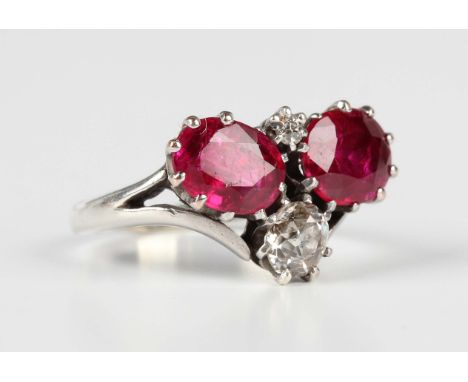 A white gold, diamond and red gem set ring, claw set with two oval cut red gems and two cushions cut diamonds, unmarked, weig