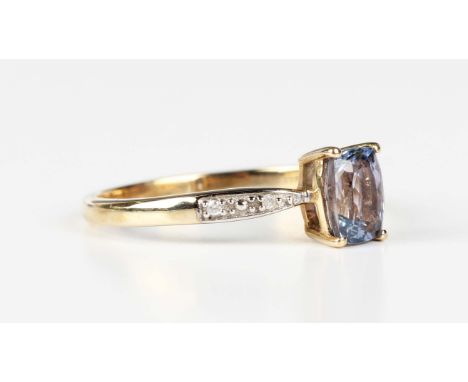 A 9ct gold ring, claw set with a cushion cut tanzanite between diamond two stone shoulders, Birmingham 2014, weight 2.1g, rin