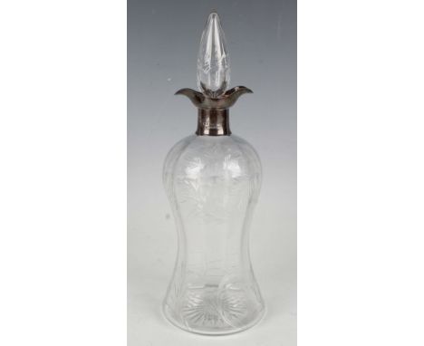 A George V silver mounted cut glass decanter and stopper, fitted with a twin-lipped pouring collar above a waisted body cut w