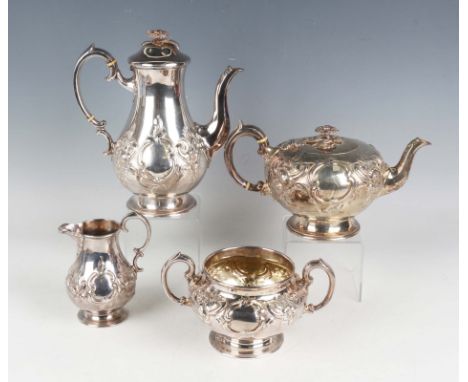 A Victorian silver harlequin four-piece tea set, each of circular form with flower finial above relief decorated 'C' scrolls 