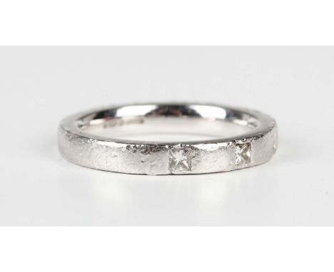 A platinum band ring, mounted with three princess cut diamonds, weight 7.2g, ring size approx K1/2.Buyer’s Premium 29.4% (inc