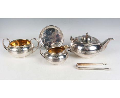 A George III harlequin silver four-piece tea set of squat circular girdled form, crest engraved, comprising teapot, London 18