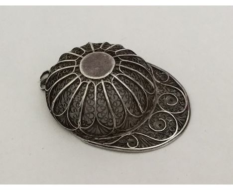 An 18th Century silver filigree caddy spoon in the form of a jockey cap. Approx. 8.2 grams. Est. £100 - £150.
