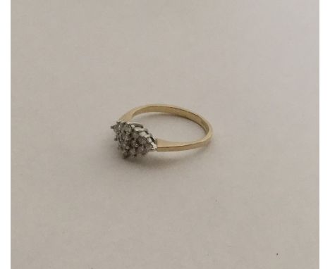 A diamond circular cluster ring in 9 carat two colour gold. Approx. 1.8 grams. Est. £50 - £60.