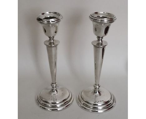 A tall pair of tapering circular silver candlesticks. Birmingham 1915. By WA. Approx. 336 grams. Est. £50 - £80.