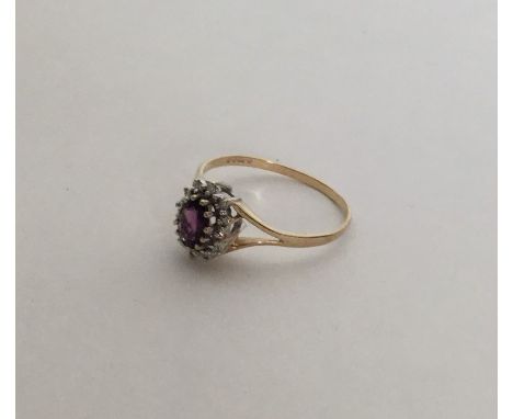 An amethyst and diamond circular cluster ring. Approx. 2.4 grams. Est. £60 - £80.