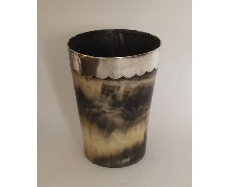 A tapering silver mounted horn beaker with glass base. Approx. 9 cms high. Est. £25 - £35.