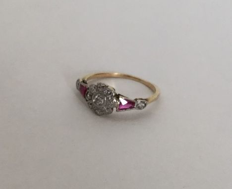 An attractive ruby and diamond daisy head cluster ring with tapering shoulders. Approx. 1.8 grams. Est. £80 - £120.