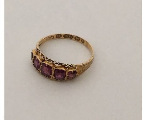 An Antique garnet five stone ring of tapering form. Approx. 2 grams. Est. £50 - £80.