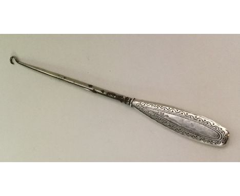 LIBERTY &amp; CO: A stylish silver button hook of typical form. Approx. 70 grams. Est. £25 - £35.