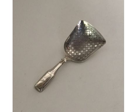 A Victorian silver bright cut caddy spoon with wriggle work decoration. Approx. 11 grams. Est. £30 - £50.