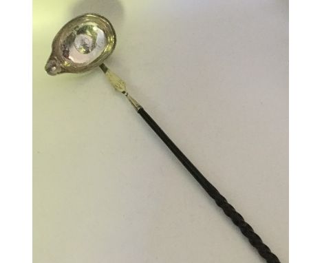 A Georgian silver toddy ladle with whalebone handle and pouring lip. Approx. 43 grams. Est. £40 - £50.