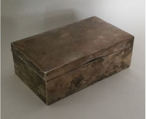A rectangular dome top silver cigarette box. Birmingham. By GFW. Approx. 470 grams. Est. £60 - £80.