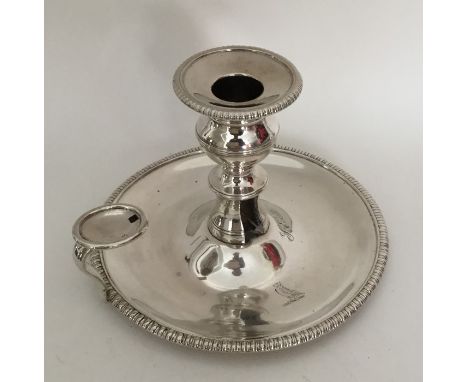 A Antique American silver chamber stick with reeded border and crested side. By VIF. Approx. 320 grams. Est. £250 - £300.