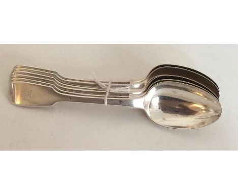 A heavy set of six fiddle pattern silver dessert spoons. London. By HL. Approx. 311 grams. Est. £100 - £150.