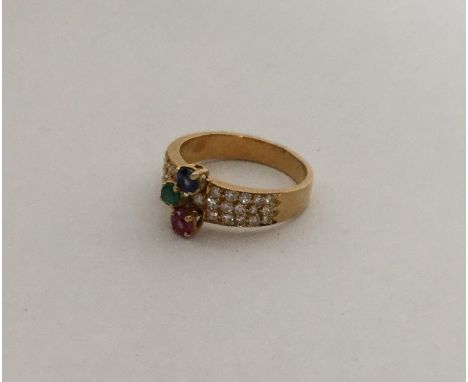 A good quality French sapphire, ruby and emerald ring with diamond shoulders. Approx. 4.8 grams. Est. £150 - £200.