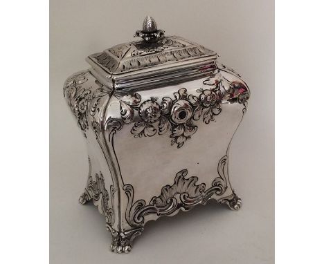 A good Georgian silver bombe tea caddy attractively decorated with flowers and leaves to tapering scroll feet. London 1760. B
