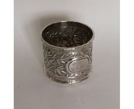 A Chinese silver napkin ring decorated with bamboo shoots. Approx. 25 grams. Est. £15 - £20.