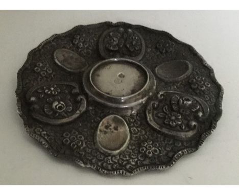 An unusual Turkish circular silver dish decorated with flowers. Punched to centre and assay scrape to reverse. Approx. 44 gra