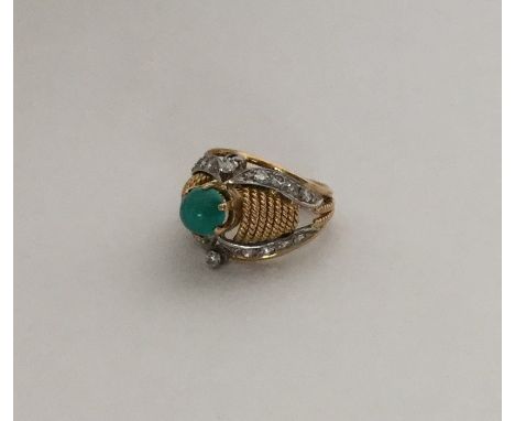 An 18 carat two colour gold diamond and turquoise modernistic ring. Approx. 6.4 grams. Est. £200 - £300.
