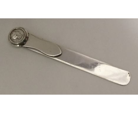 An Edwardian silver letter opener inset with coin. London. By AP. Approx. 36 grams. Est. £30 - £50.