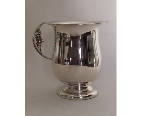 An Edwardian silver christening cup with a 'Man In The Moon' handle. Birmingham. Approx. 80 grams. Est. £75 - £85.