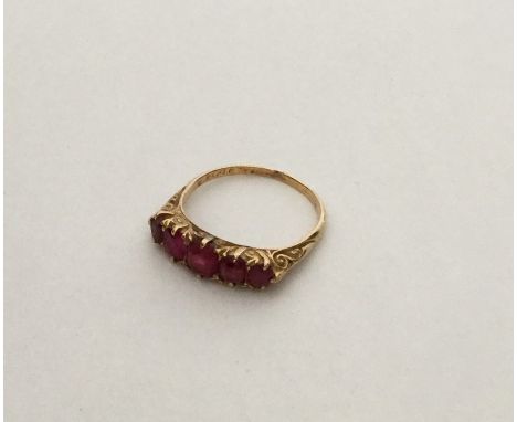 An 18 carat ruby five stone tapering ring in claw mount. Approx. 3.1 grams. Est. £200 - £300.