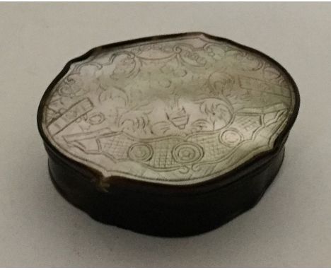 A shaped Georgian MOP and tortoiseshell snuff box with scroll decoration. Approx. 32 grams. Est. £20 - £30.