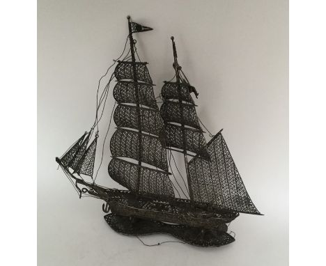 A large silver filigree model of a sailing boat. Approx. 109 grams. Est. £60 - £80.