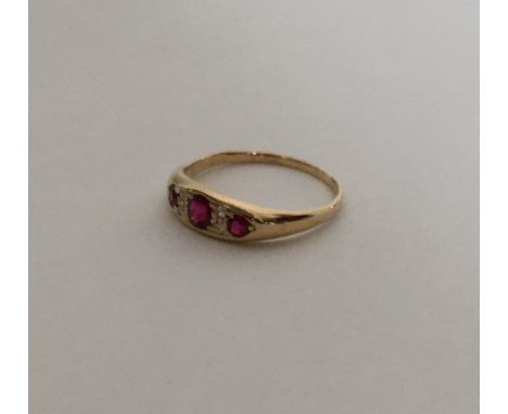 A ruby and diamond seven stone ring in 18 carat mount. Approx. 3.8 grams. Est. £150 - £200.