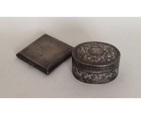 A small engine turned silver cigarette box together with a Continental pill box. Approx. 95 grams. Est. £20 -  £30.