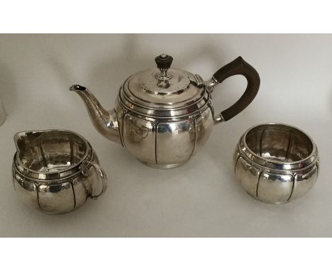 LIBERTY &amp; CO: An attractive bachelor's three piece silver tea service of panelled design. Numbered to base 50163. Approx.