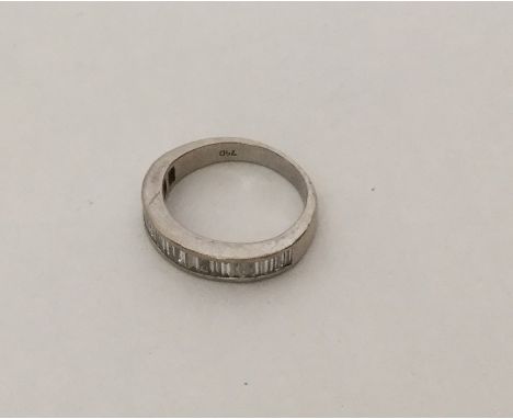 An 18 carat white gold baguette cut diamond half eternity ring. Approx. 4.5 grams. Est. £150 - £200.