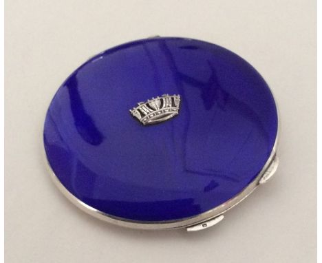 A silver and enamelled compact with fitted interior. Approx. 104 grams. Est. £60 - £80.
