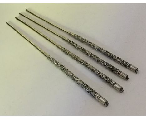 Two pairs of Chinese silver chopsticks decorated with flowers. Approx. 60 grams. Est. £40 - £60.