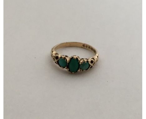 A 9 carat three stone turquoise ring. Approx. 2.2 grams. Est. £40 - £60.