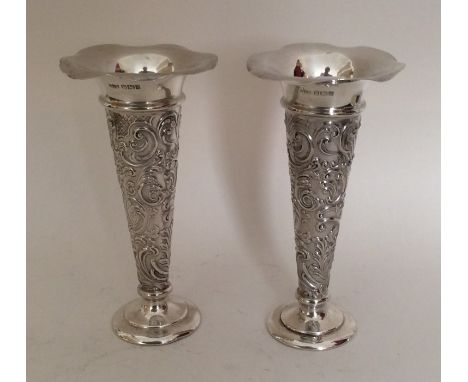 A good pair of silver embossed vases. Sheffield  1902. By Mappin &amp; Webb. Approx. 290 grams. Est. £70 - £80.