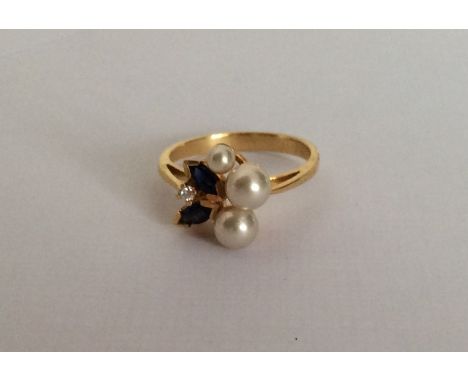 A Continental 18 carat sapphire, diamond and pearl six stone ring in fancy band. Approx. 4.2 grams. Est. £100 - £150.